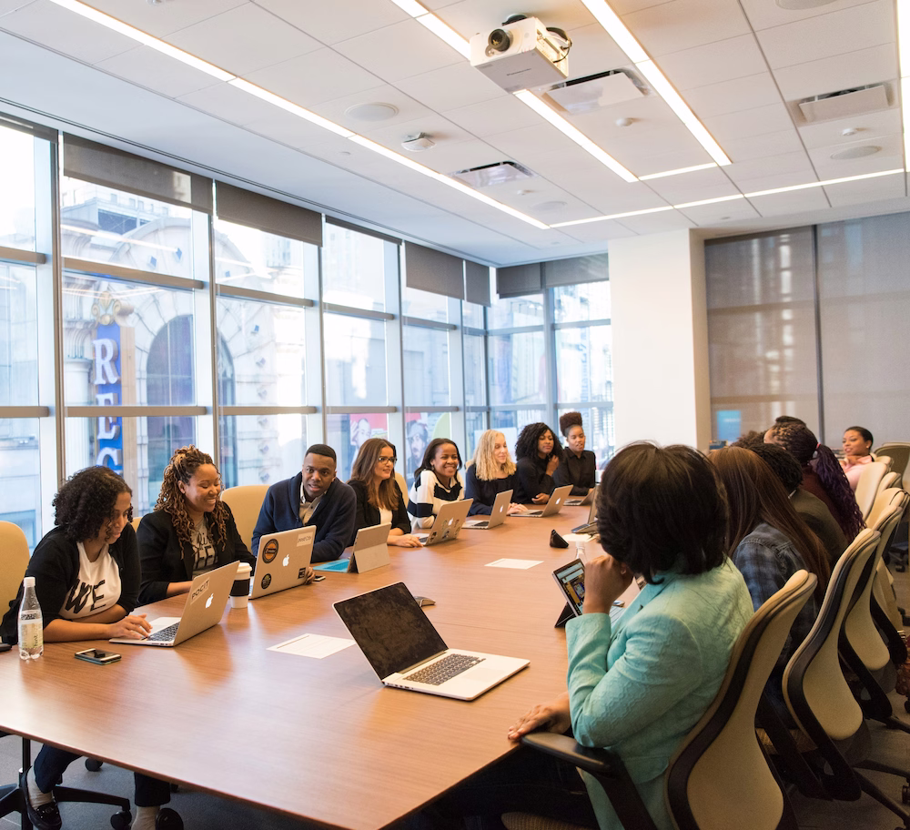 A leadership team meeting around a boardroom table