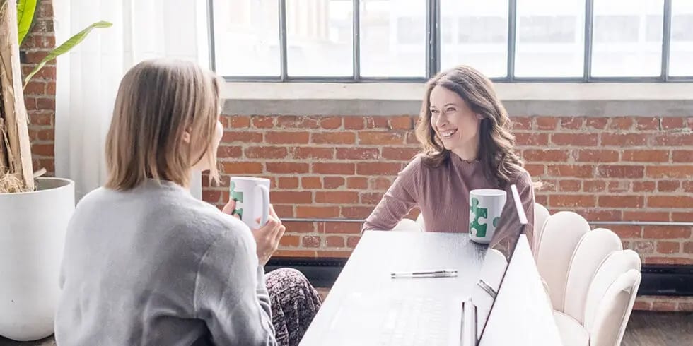 Two colleagues discussing results across a table