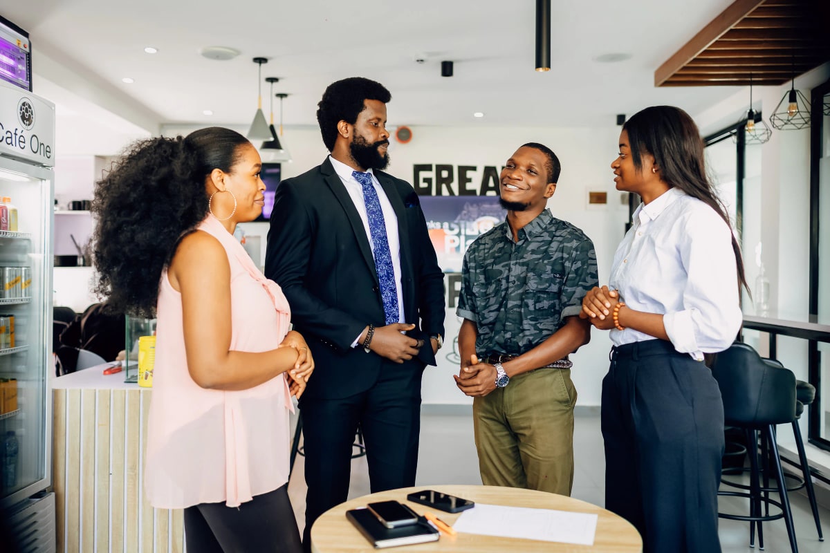Four colleagues in conversation in a bright office